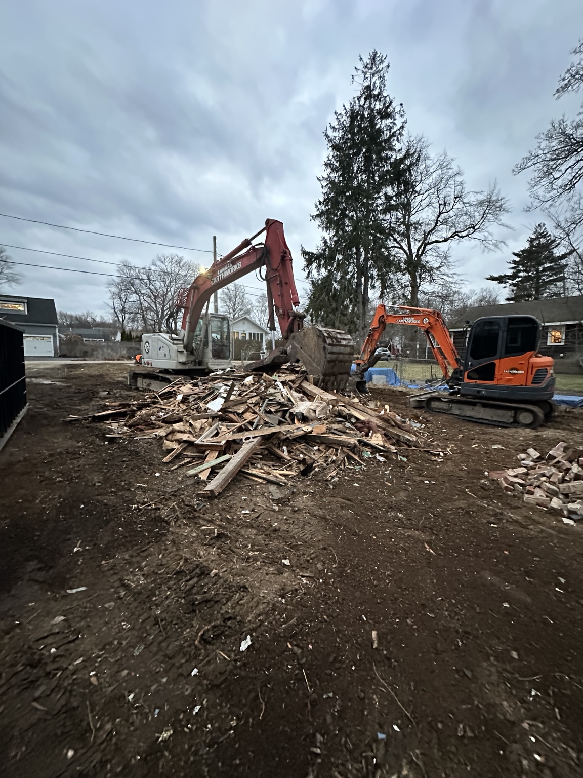 Excavators sorting and clearing demolition debris