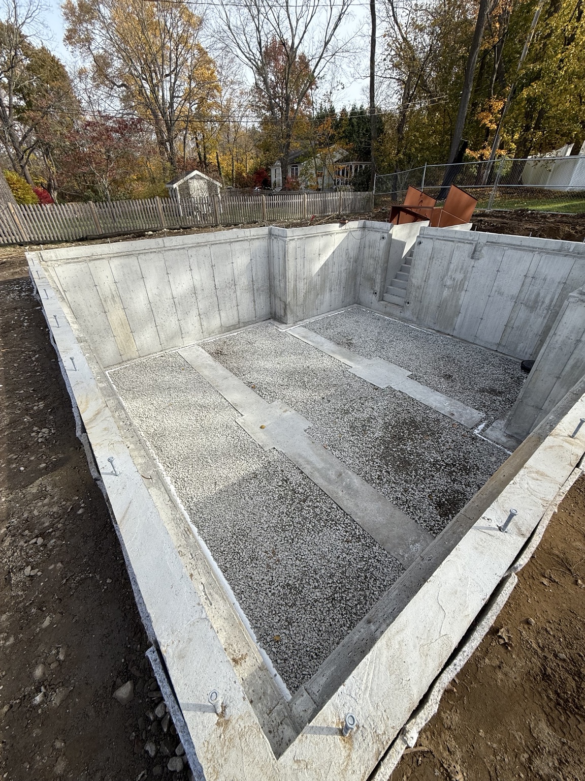 Completed concrete foundation walls with prepared stone base