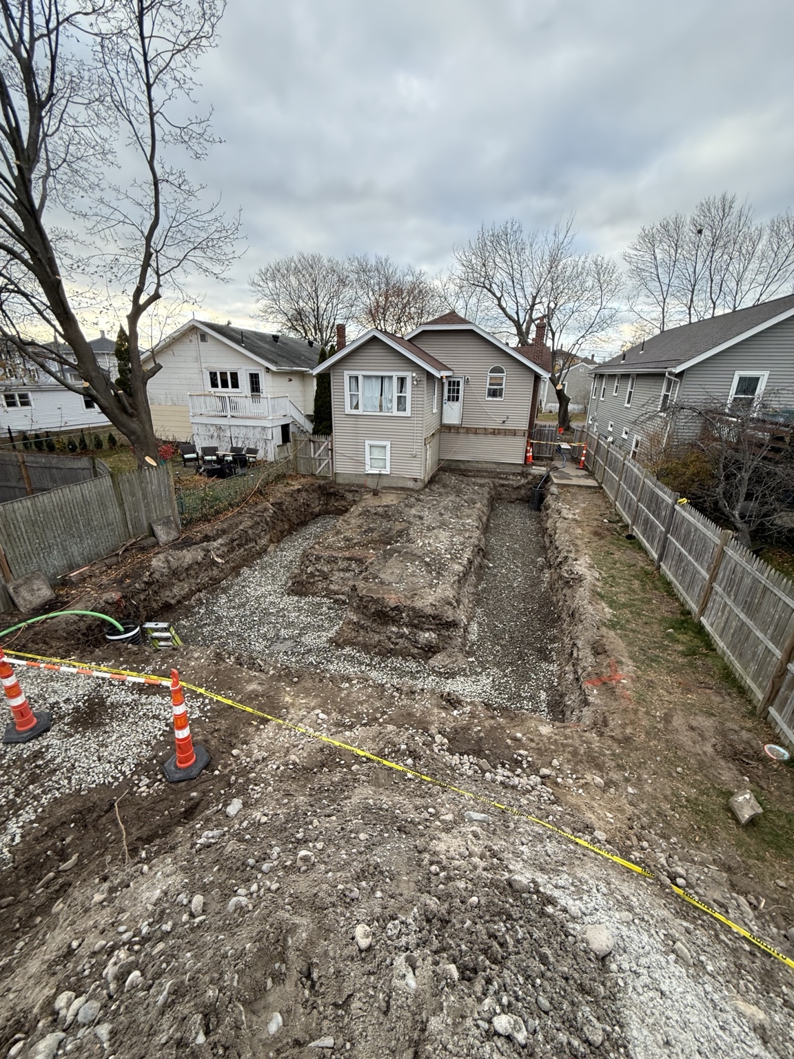 Residential addition foundation excavation with compacted stone base